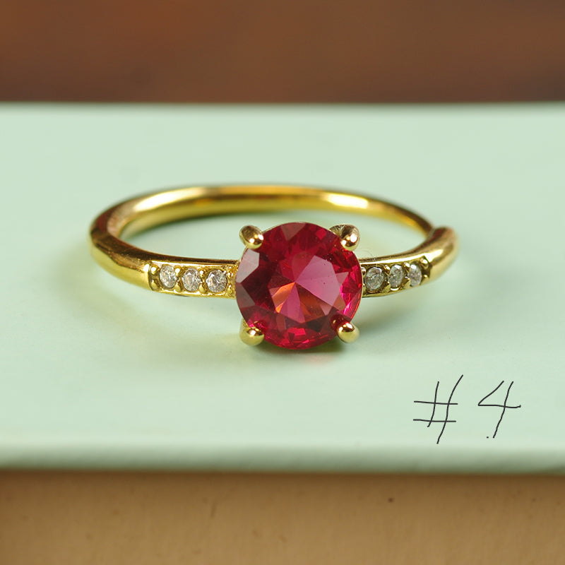 Gold ring with a red gemstone